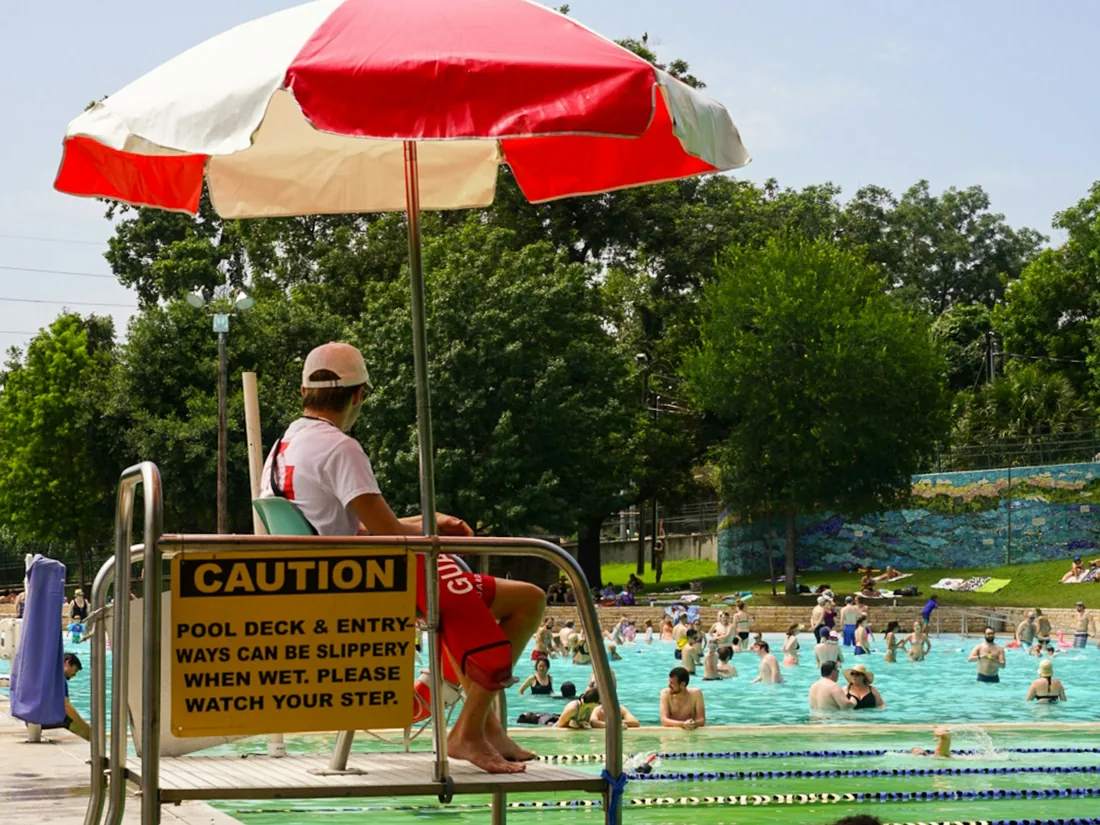 Lifeguard on duty watching swimmers at a community pool
